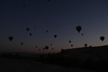 Silhouettes of hot air balloons at sunset sky. Goreme National Park. Cappadokia, Turkey.