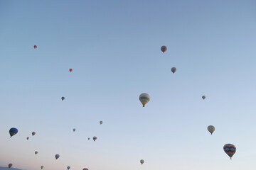 Hot air balloons flight in the sky. Colorful hot air balloons flying on blue sky background.