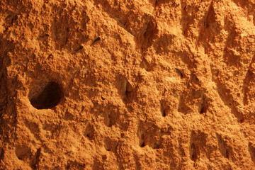 Cave stone texture background. Detailed view of the rock wall of an ancient cave house.