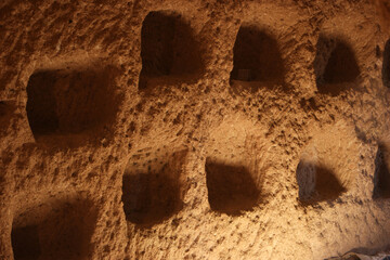 Rock sandstone wall of an ancient house of Cappadocia. Beautiful texture of the wall of an ancient cave dwelling. Cappadocia, Turkey.