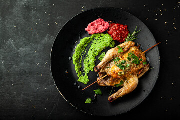 Grilled chicken with sauce and green peas on plate