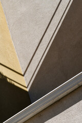 Geometric shadows on the wall of a building