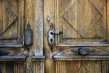 Old metal door handle and decor on door in Wurzburg, Germany.