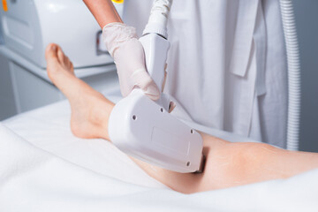 Woman at salon having a procedure of laser hair removal .