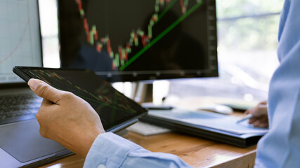 Fototapeta premium Stock Market Broker in formalwear Analyzing Graphs on screens in the office, investment concept.