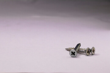 Metal self-tapping screws on a white background.