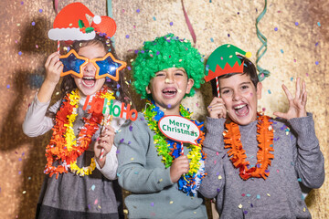 Three kids celebrating New Years Eve Christmas Day at home