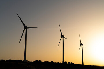 Scenic view of windmill farm on sunny spring day