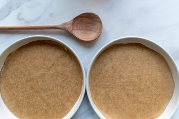 two sandwich cake tins lined with baking paper 