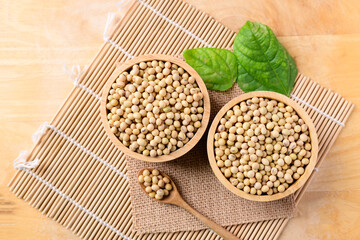 Soy beans in a bowl on wooden background