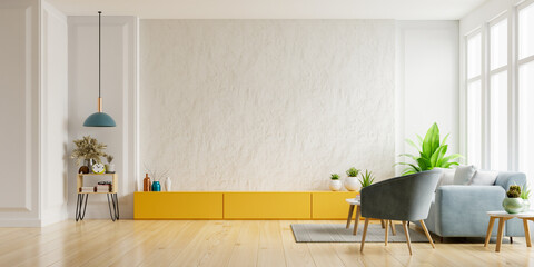 Cabinet for TV on the white plaster wall in living room with armchair and sofa,minimal design.