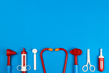 toy medical doctor's tools on a blue background. Space for text