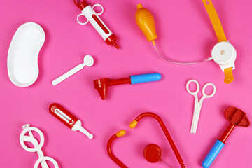 Background of toy medical doctor tools on pink background