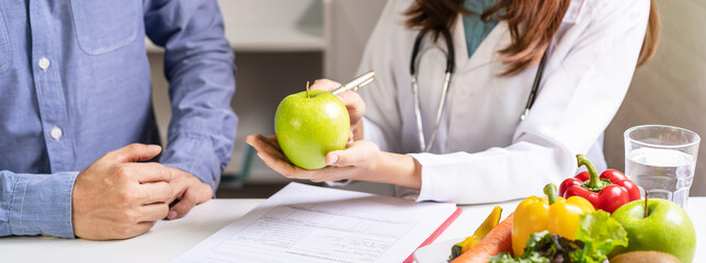 Nutritionist giving consultation to patient with healthy fruit and vegetable, Right nutrition and...