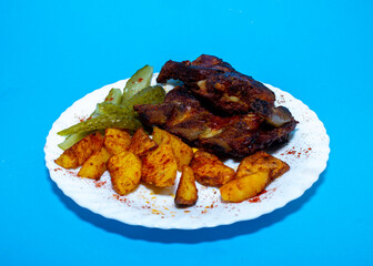 Fried ribs. American honey marinade. blue background