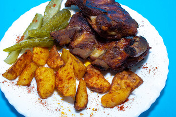 Fried ribs. American honey marinade. blue background