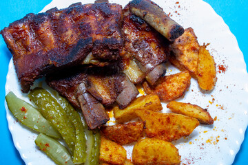 Fried ribs. American honey marinade. View from above on a blue background