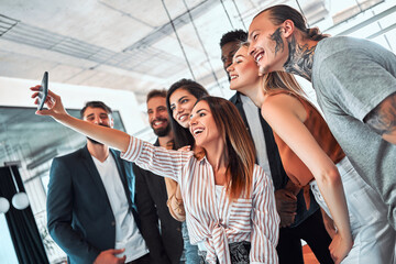 Creative business team taking a selfie in the office