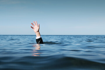 Hand Raised Above the Sea, Businessman Drowning.