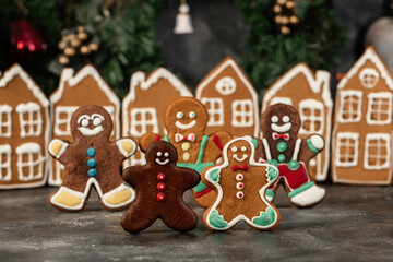 Various christmas gingerbread cookies on dark table with flour