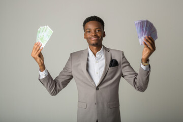 handsome young african male on white background with euro money in hands