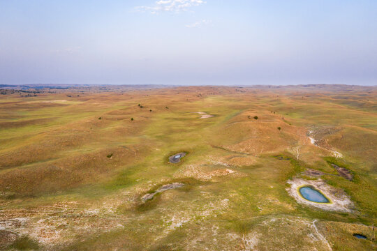 landscape of Nebraska Sandhills, early morning aerial view at Nebraska National Forest with cattle water holes