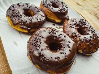chocolate doughnuts on a carton plate