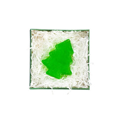 Christmas green box of soap in the shape of green spruce, christmas tree isolated on a white background. Box package with white paper filler, top view. Xmas gift concept