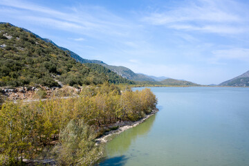 Fototapeta premium The beautiful landscapes of Kovada Lake, mountains and green area from the air. Isparta Lake District, TURKEY 
