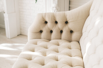 White textile comfortable sofa in elegant living room. Close-up