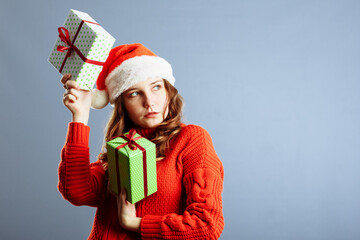 Happy europian Santa Woman is smiling and holding Gift Box for Christmas or New Year. Isolated on gray background