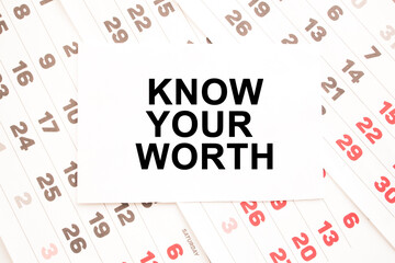 text KNOW YOUR WORTH on a sheet from Notepad.a digital background. business concept . business and Finance.