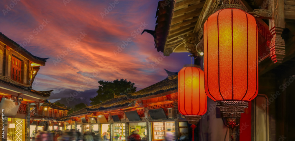 Wall mural lijiang old town in the evening with crowed tourist.