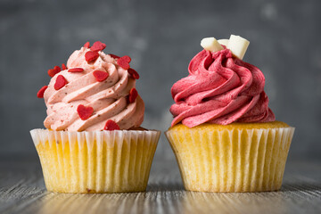 Strawberry and Raspberry frosty cupcake on a table