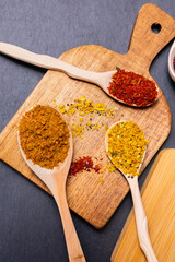 seasonings and spices on a stone black background. The view from the top. flat lay. vertical photo
