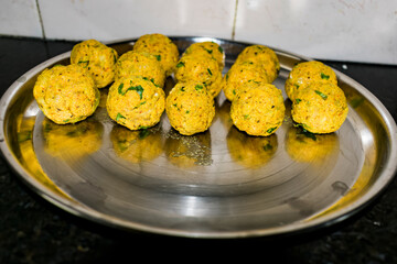  Indian Vegetarian koftas made with bottle gourd and gram flour as a main ingredients with onion, coriander leaf other ready for frying.
- 387813301