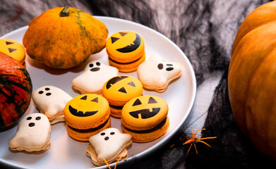 Macaroons for halloween holiday party on white plate. Creative idea for Halloween treats, funny...