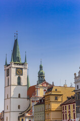 Fototapeta na wymiar Colorful houses and tower of the All Saints church in Litomerice, Czech Republic