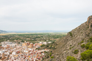 Fototapeta na wymiar Cullera city from an aerial view. Beautiful panorama of the city and the mountains in the background. Photography taken from the historic Castle.