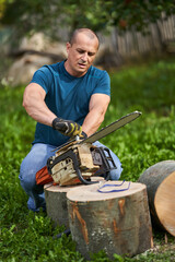 Lumberjack servicing his chainsaw