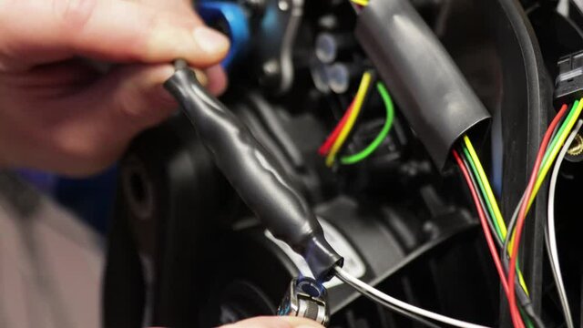 Electric bicycle repair. Installing heat shrink tubing on wires with a lighter 2