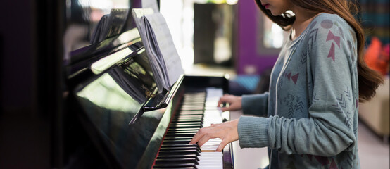 Female pianist hands play song on classic Piano - obrazy, fototapety, plakaty