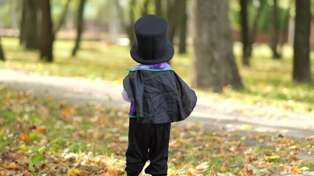 Happy Halloween! Little boy in a dracula costume and a developing cloak. Slow motion