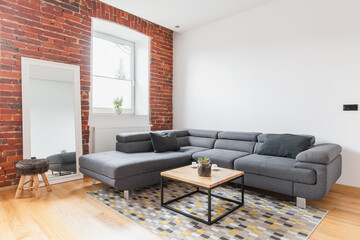 Big grey corner sofa in apartment
