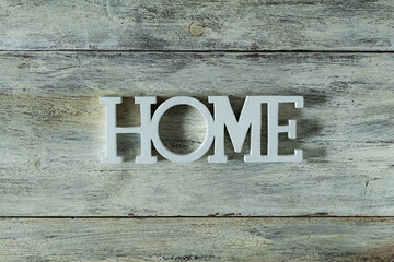 The word home on wooden background