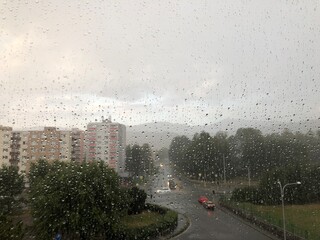 Rainy intersection from behind window.