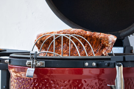 Juicy rack of ribs cooking on a bbq grill. spare ribs smoking on a bbq egg