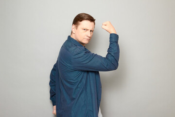 Portrait of charismatic mature man raising hand with clenched fist up