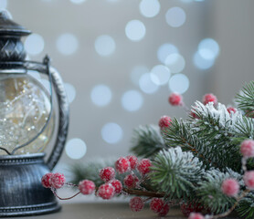 Christmas vintage lantern. Snow-covered fir branches and berries