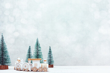 Christmas toy train travels through a miniature snowy forest